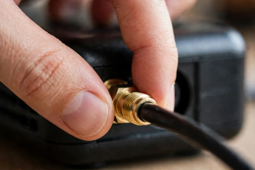 Coaxial cable being screwed into the back of an Xfinity modem
